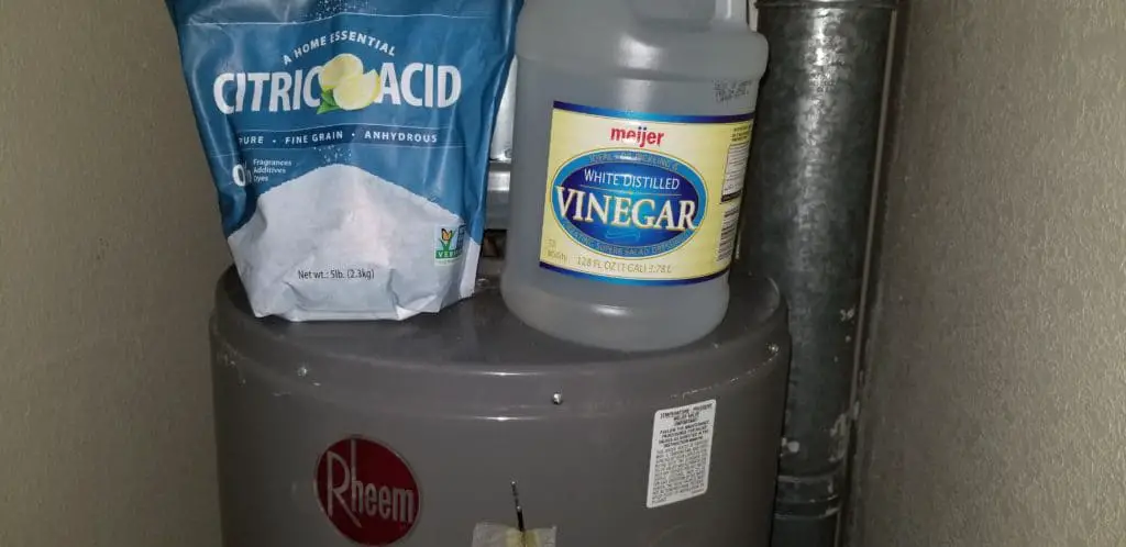 citric acid or vinegar to soften and dissolve calcium carbonate deposits in water heater tank
