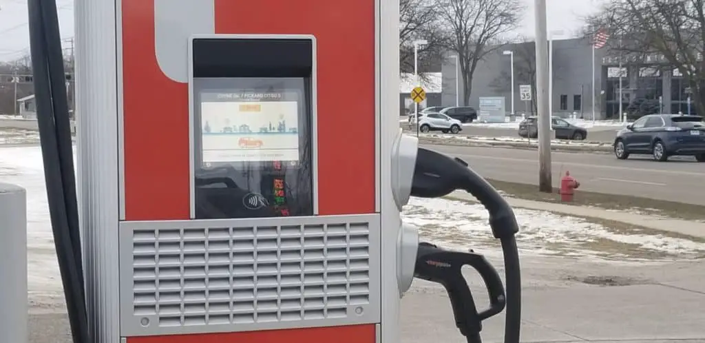 Image of an electric vehicle charging hub at a local gas station.