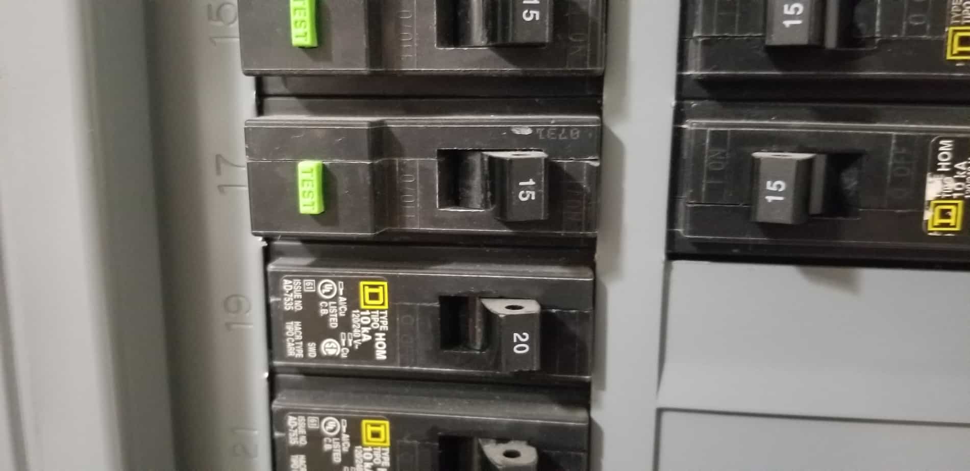 Image of a main breaker panel with 120V single pole 15 and 20-amp breakers. 