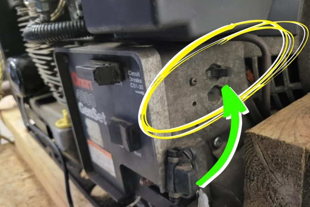 image showing where an accidentally tripped circuit breaker is located on an Onan RV generator.