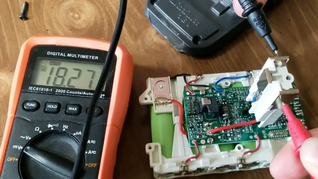Testing the voltage of a Ryobi battery where it connects to a tool or charger.