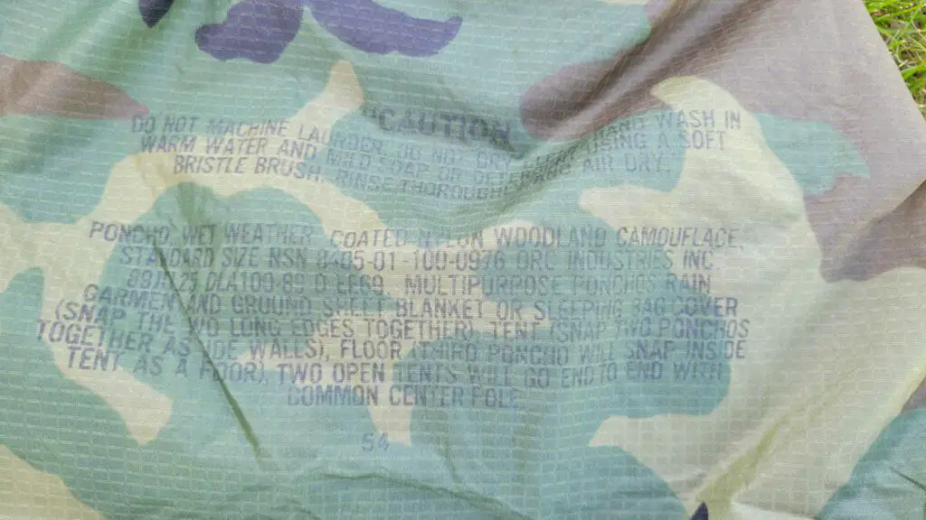 Image of USGI woodland camo poncho NSN numbers.