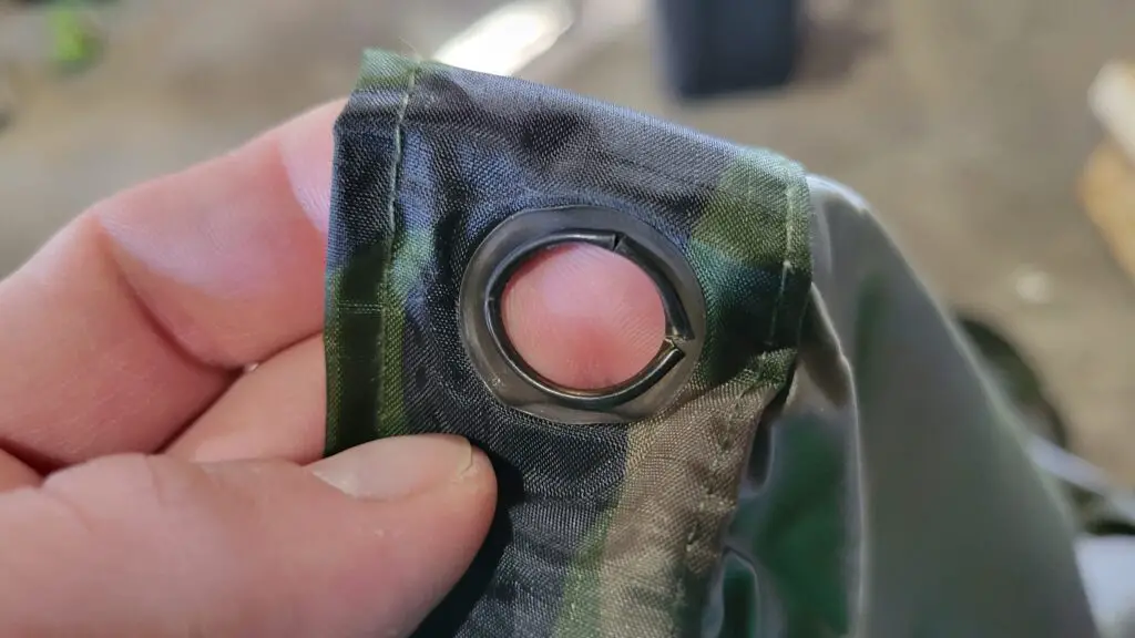 Image showing a damaged grommet on the Angolan Military surplus poncho.