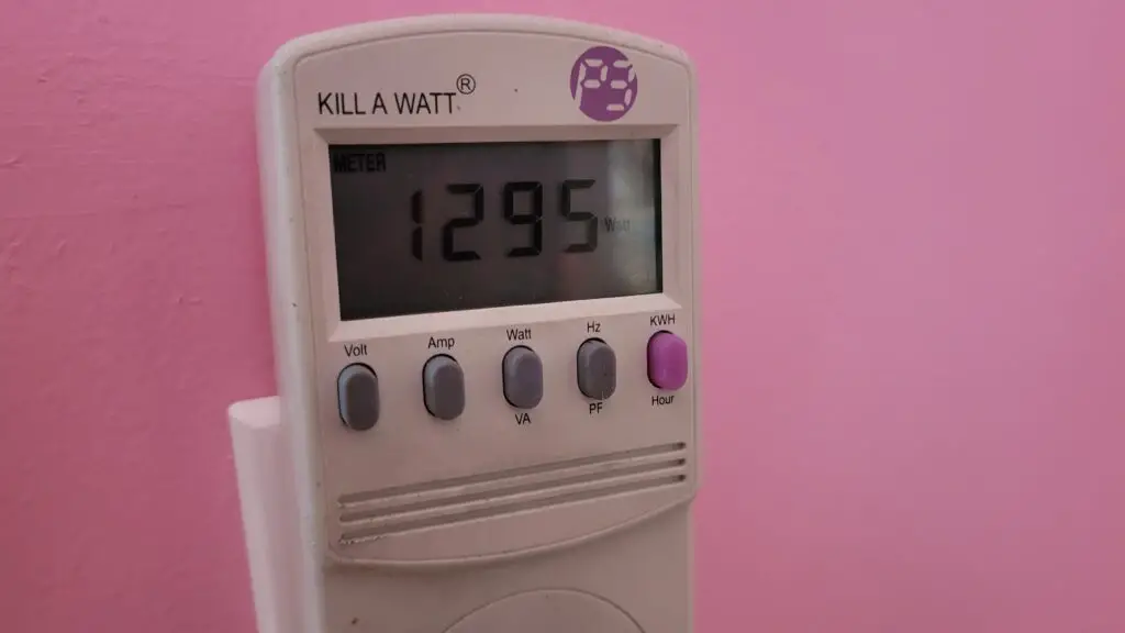 image showing how to measure the watts of an appliance with a Kill a Watt meter for properly sizing a generator to run multiple appliances at oncel