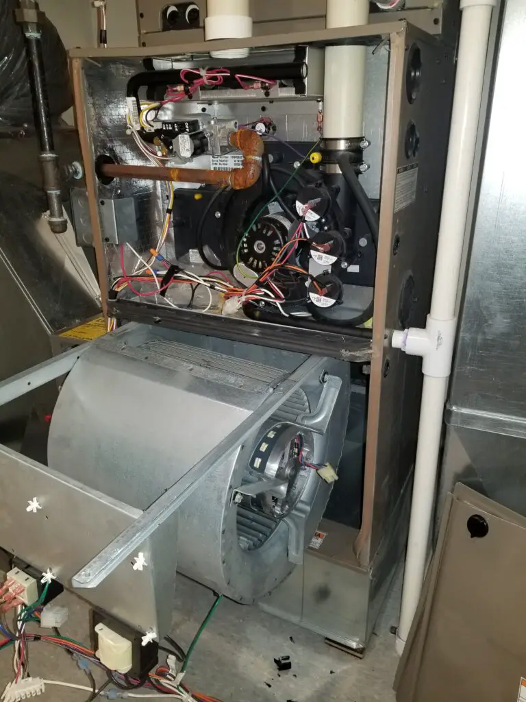 image showing a blower motor being removed from an HVAC system
