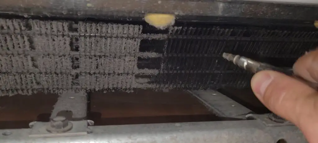 image showing how to clean refrigerator coils at home with an air compressor