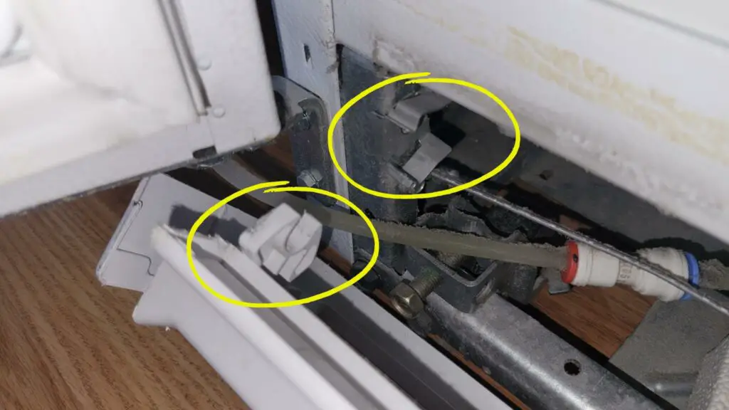 image showing how to remove the bottom grill on a fridge to access and clean the condenser coils