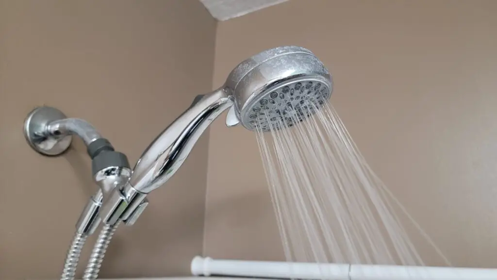 image of a shower head with water spraying out